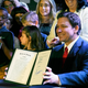 Florida Gov. Ron DeSantis holds up a 15-week abortion ban law after signing it, Thursday, April 14, 2022, in Kissimmee, Fla.